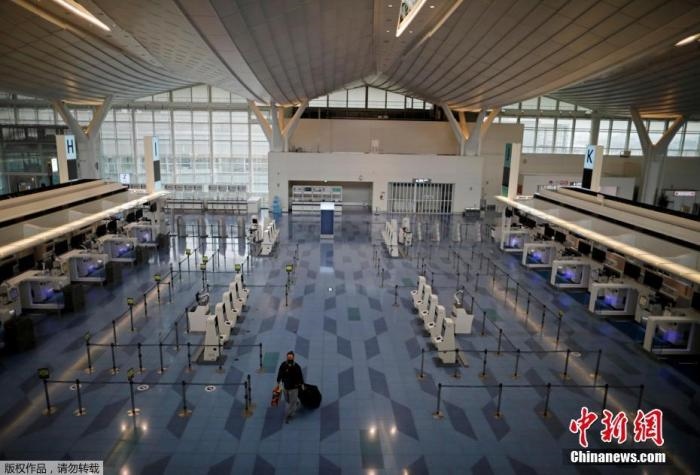 資料圖：日本東京，東京國際機場，一名乘客在國際航班航站樓的登機區(qū)。