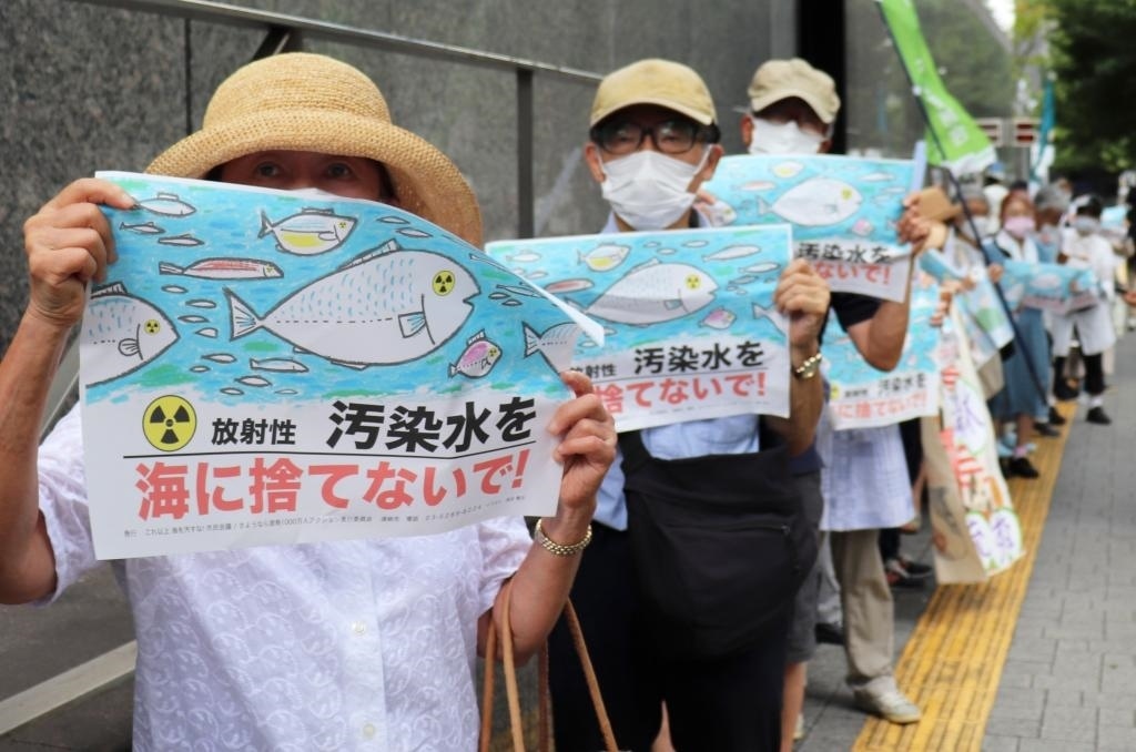 8月24日，日本民眾手持“不要將污染水扔進大?！钡葮苏Z在東京電力公司總部前集會，抗議日本政府和東電公司無視民意啟動核污染水排海。新華社記者楊光攝