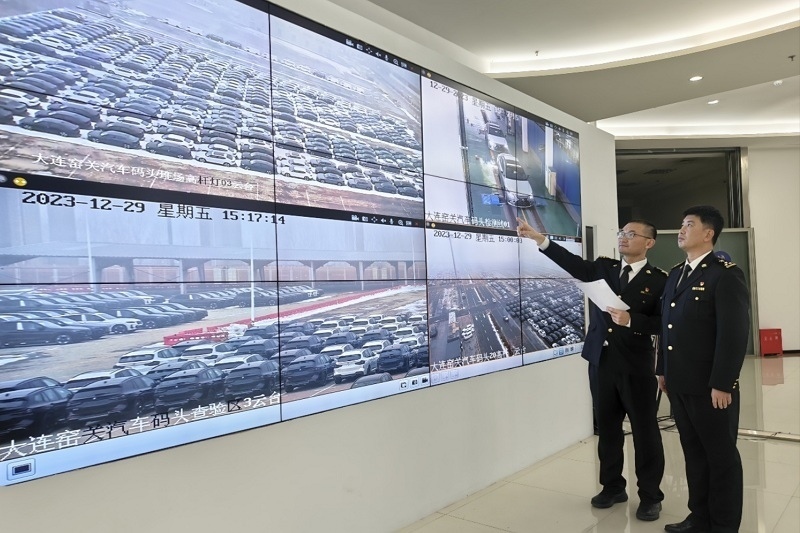 海關(guān)關(guān)員視頻巡查出口汽車場地。李進(jìn)攝