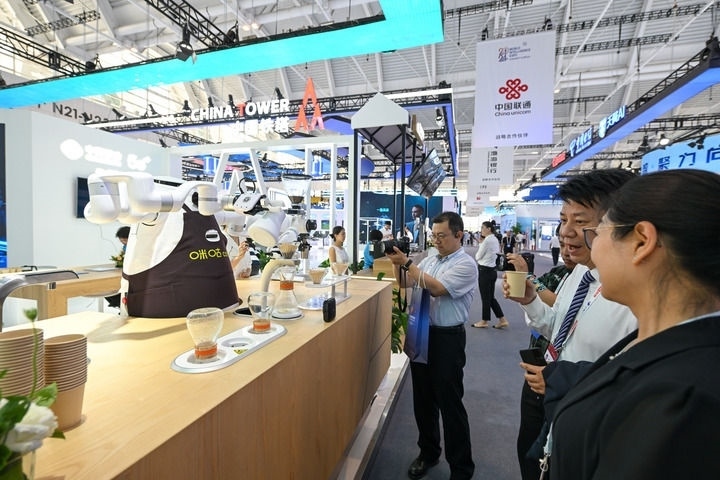 6月20日，與會(huì)者品嘗機(jī)器人沖調(diào)出的咖啡。新華社記者 孫凡越 攝