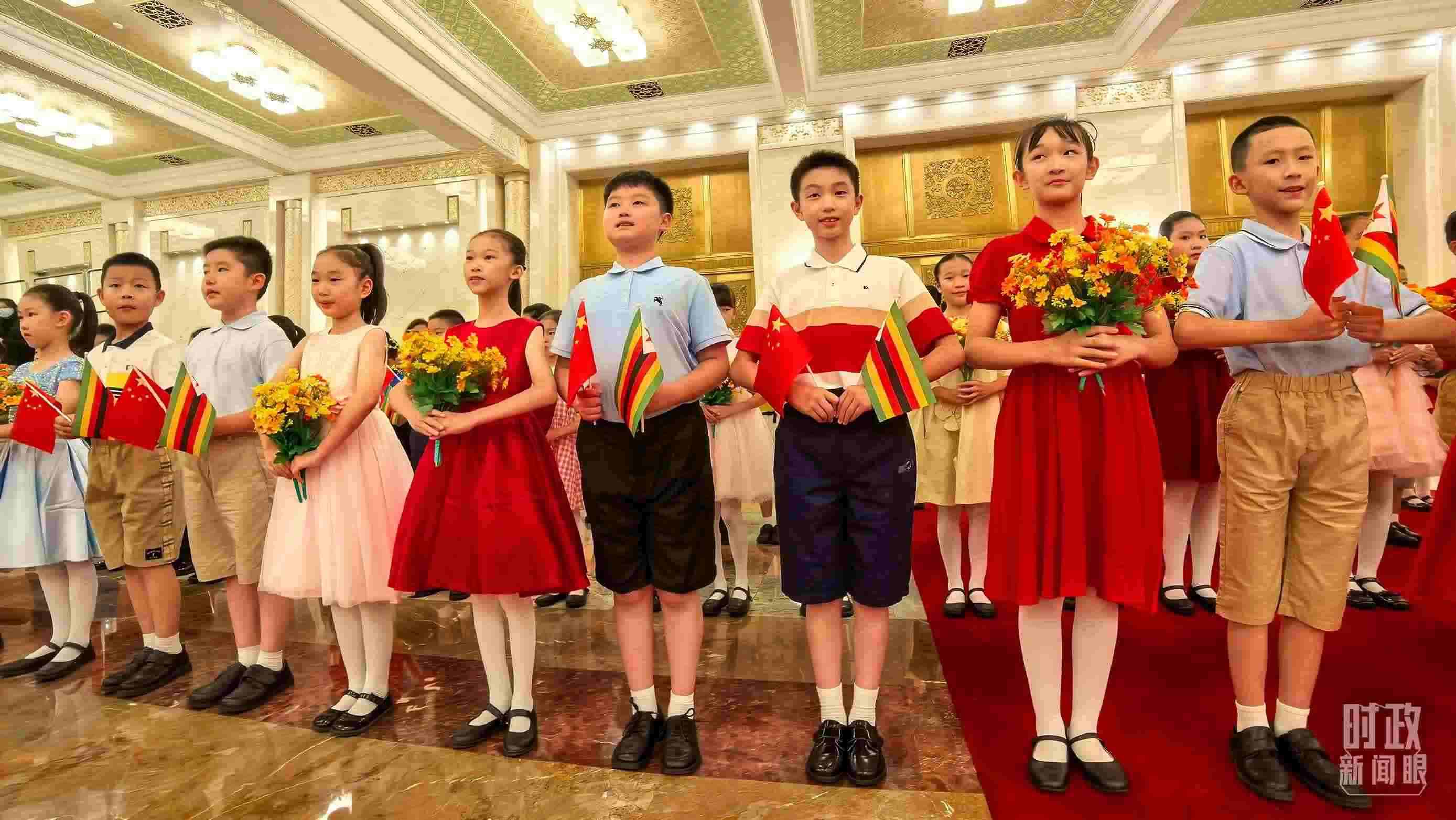 △現(xiàn)場(chǎng)歡迎津巴布韋總統(tǒng)訪華的青少年。（總臺(tái)央視記者鐘銳拍攝）