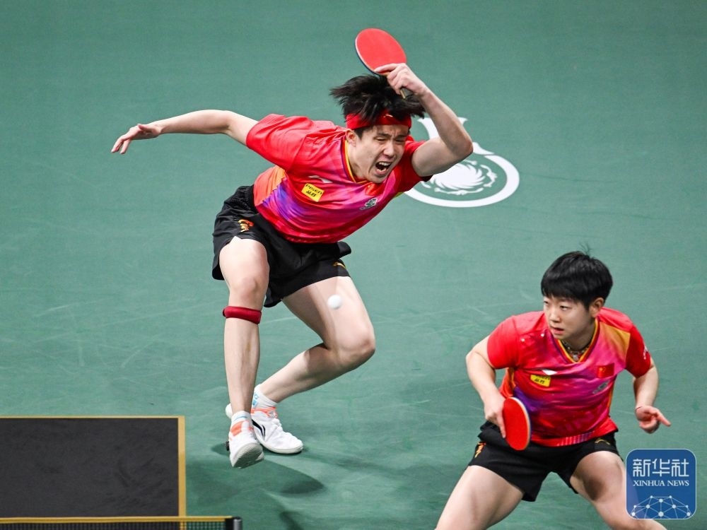 ↑中國隊(duì)組合王楚欽（左）/孫穎莎在混雙比賽中。新華社記者 王曦 攝
