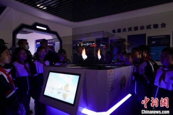 圖為學(xué)生們參觀道里區(qū)消防救援大隊消防科普體驗(yàn)館內(nèi)幻影成像燃燒三要素實(shí)驗(yàn)臺。中新社記者 趙宇航 攝